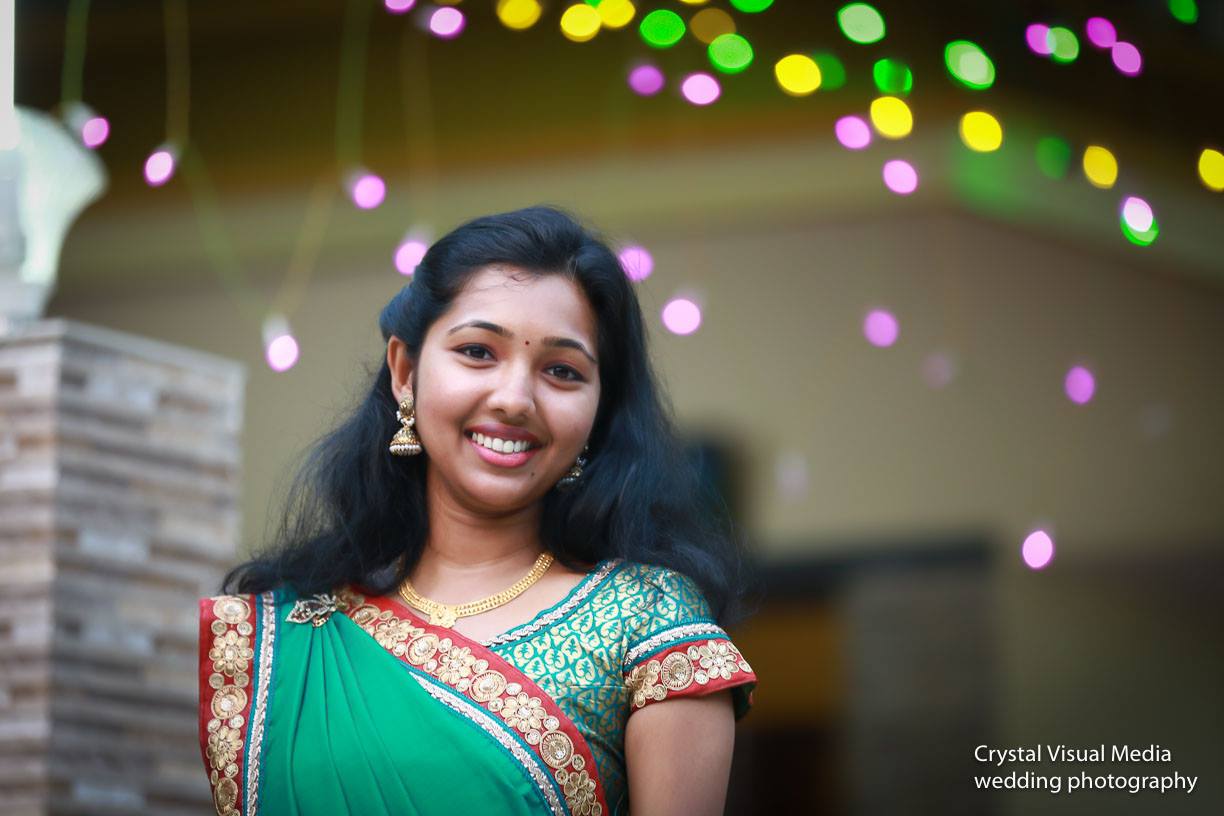 A heartfelt moment as the couple exchanges rings, surrounded by family at their Cherai engagement.