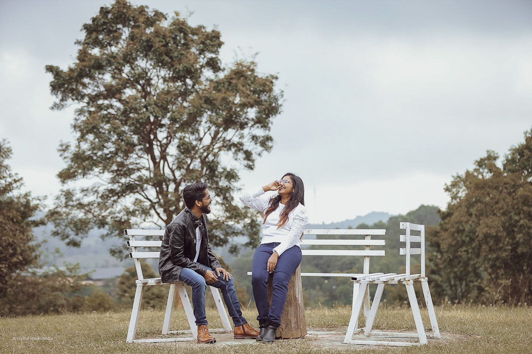 Couple sharing a laugh during their fun save the date shoot in Kerala.